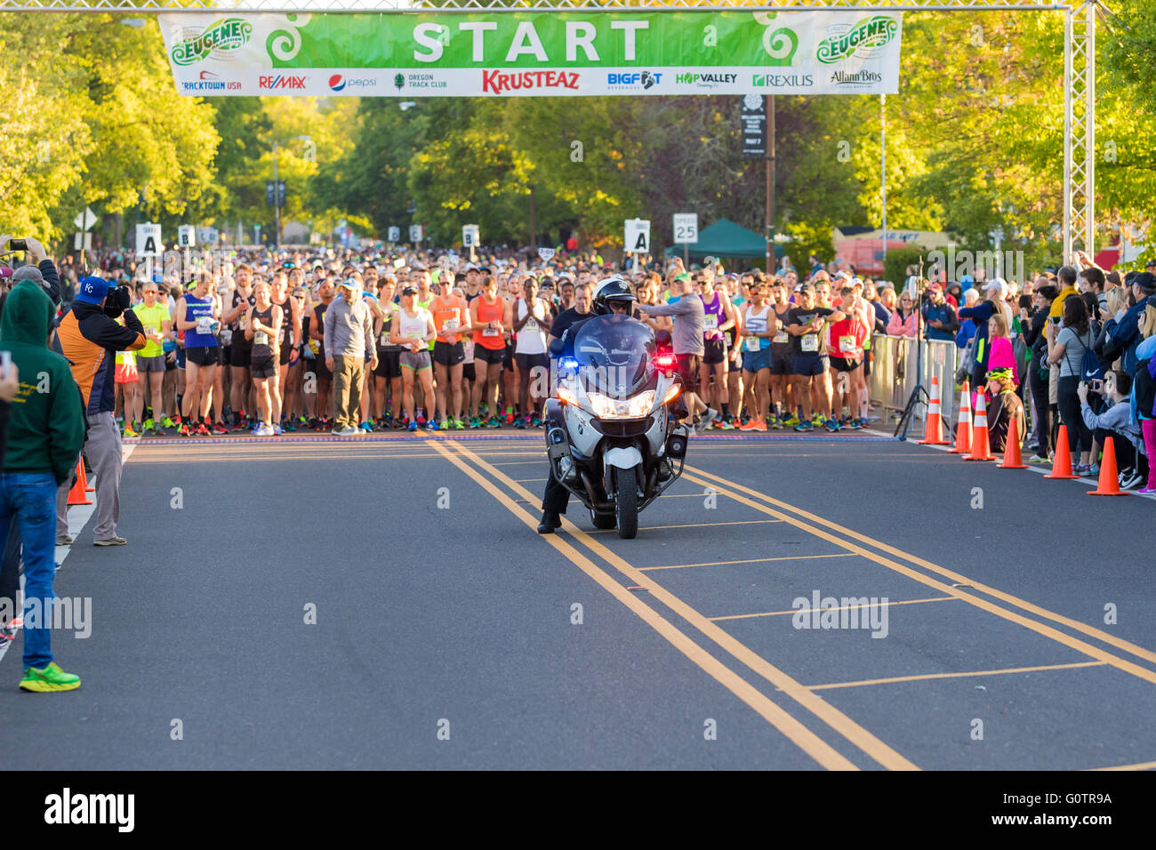 EUGENE, OR - MAY 1, 2016: Police motorcycle officer leads the pack of runners at the 2016 Eugene Marathon, a Boston qualifying e Stock Photo