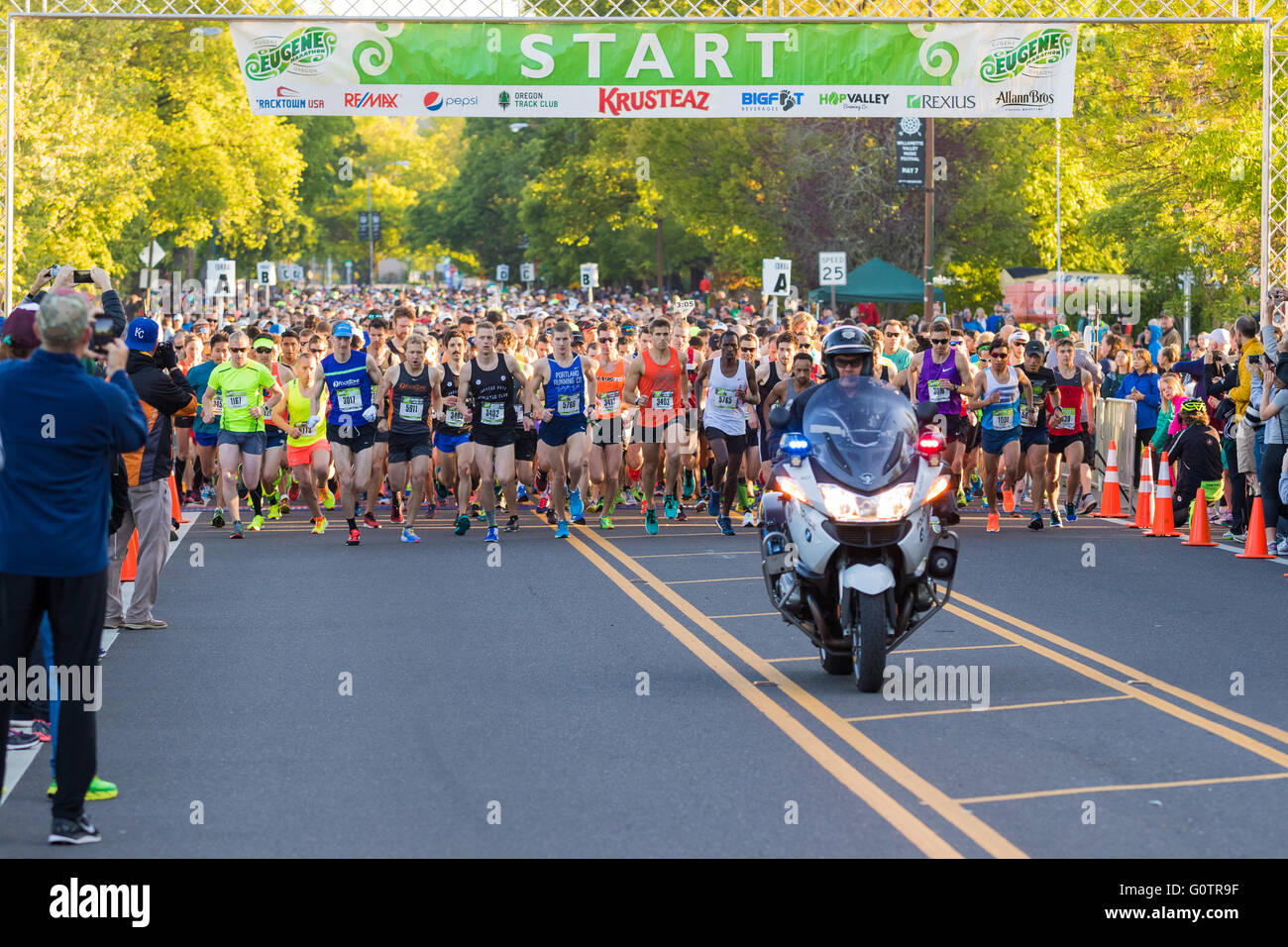 EUGENE, OR - MAY 1, 2016: Police motorcycle officer leads the pack of runners at the 2016 Eugene Marathon, a Boston qualifying e Stock Photo