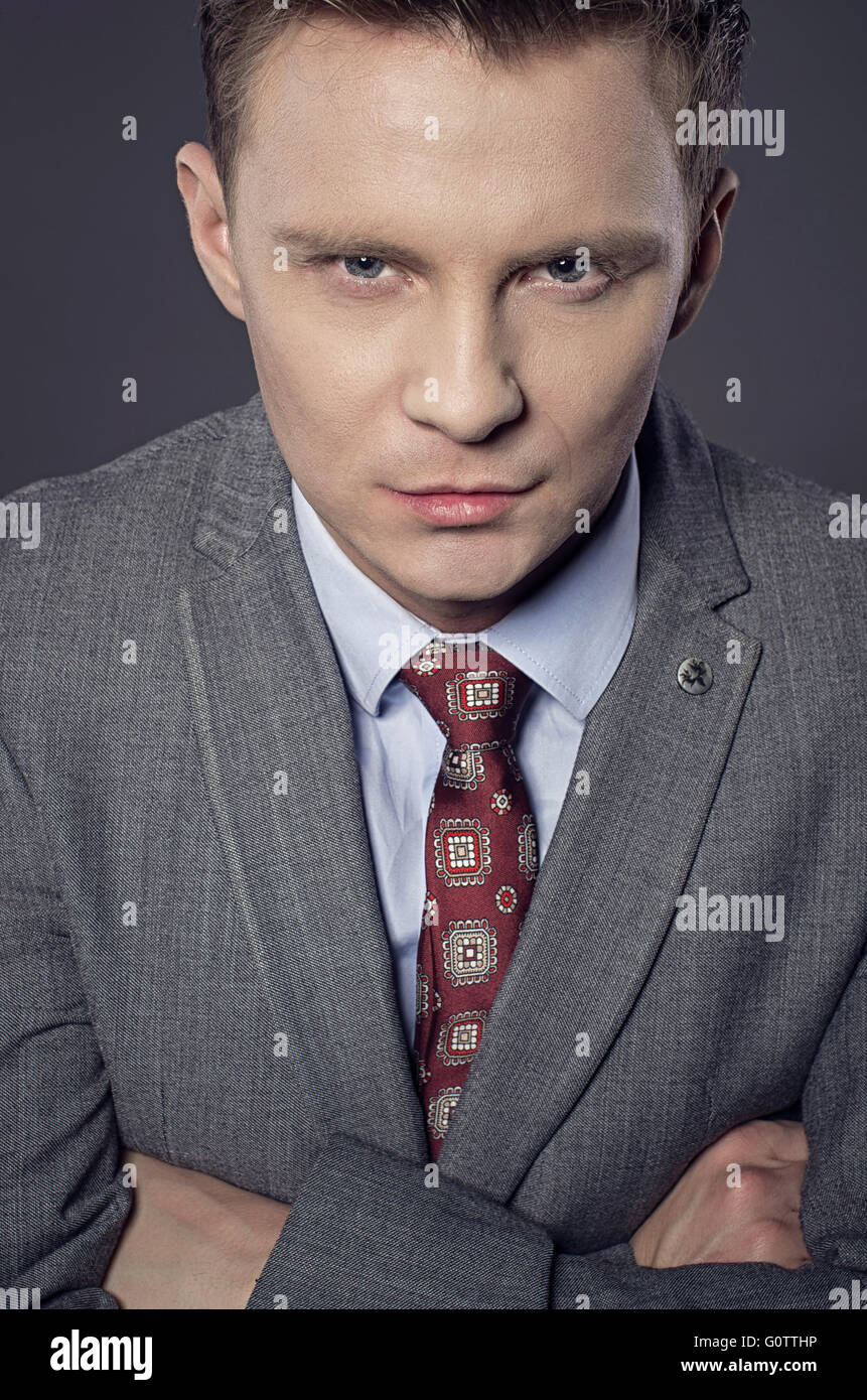 Portrait of confident young businessman in studio. Stock Photo