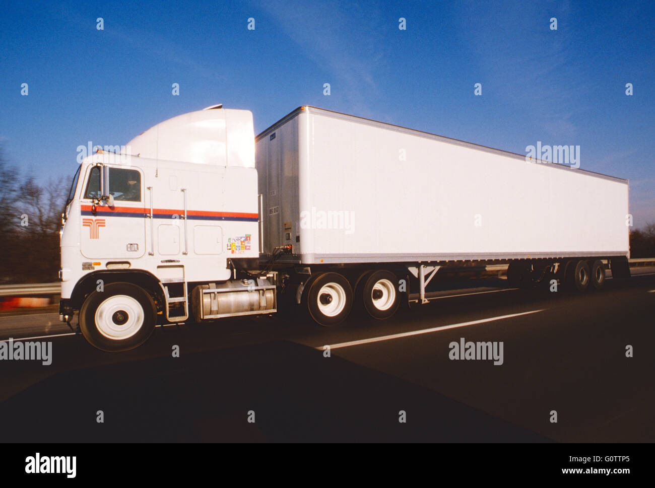 Cab over tractor trailer truck on highway Stock Photo