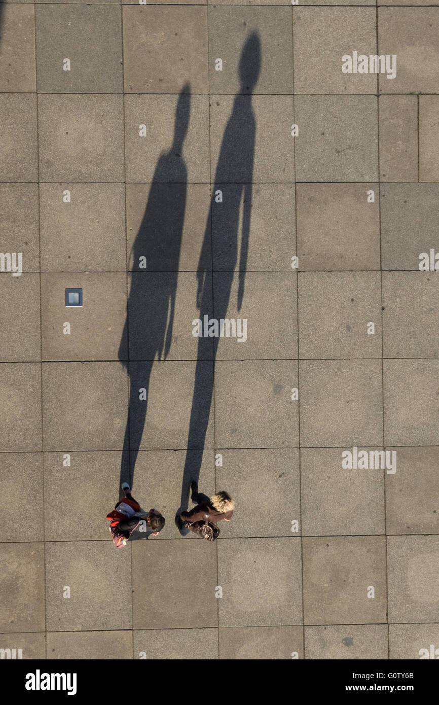 Long shadows of two people from above - aerial Stock Photo