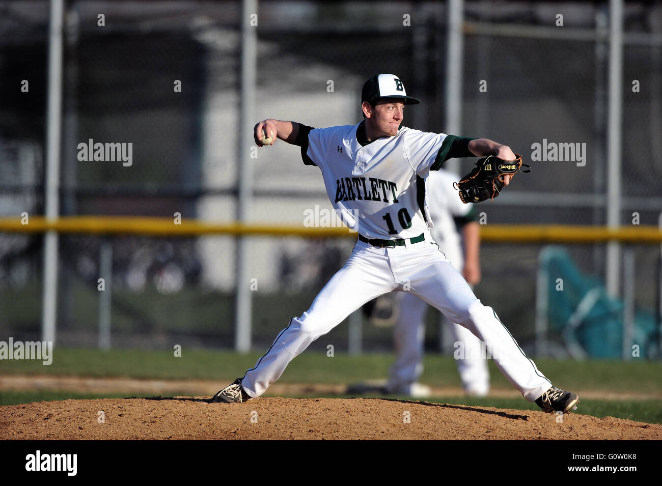Righthanded pitcher delivering a pitch to a waiting hitter during a