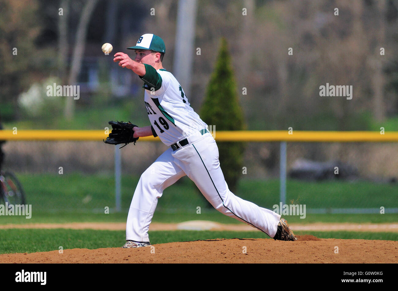 Lefthanded pitcher delivering a pitch to a waiting hitter during a