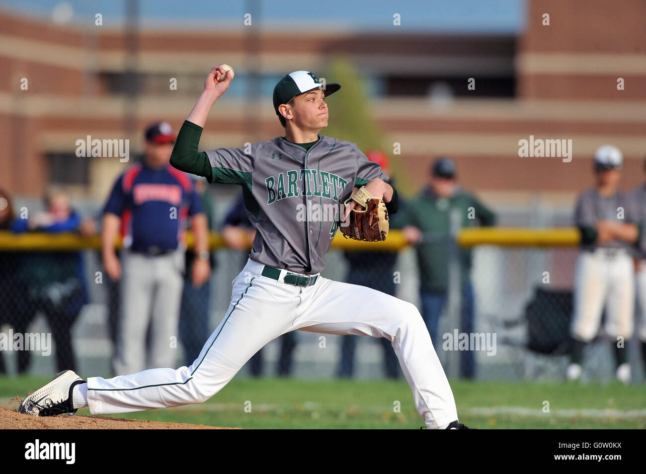 Righthanded pitcher delivering a pitch to a waiting hitter during a