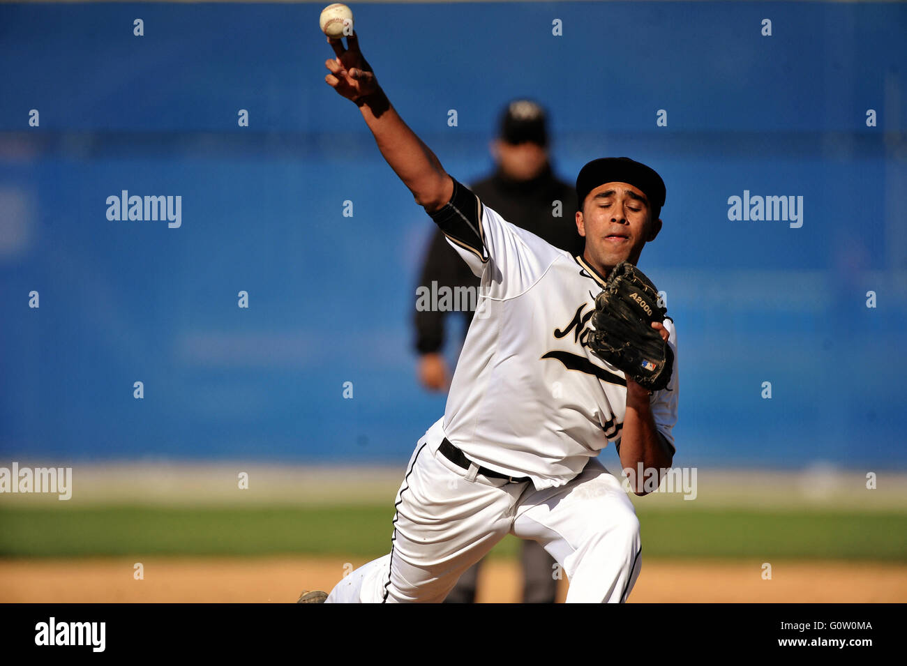 Righthanded pitcher delivering a pitch to a waiting hitter during a