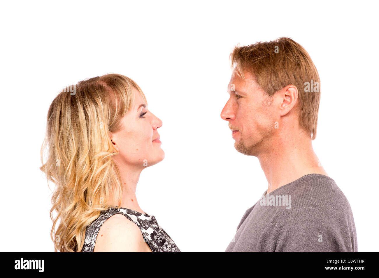 Portrait of happy couple isolated on white background. Attractive man and woman being playful. Stock Photo