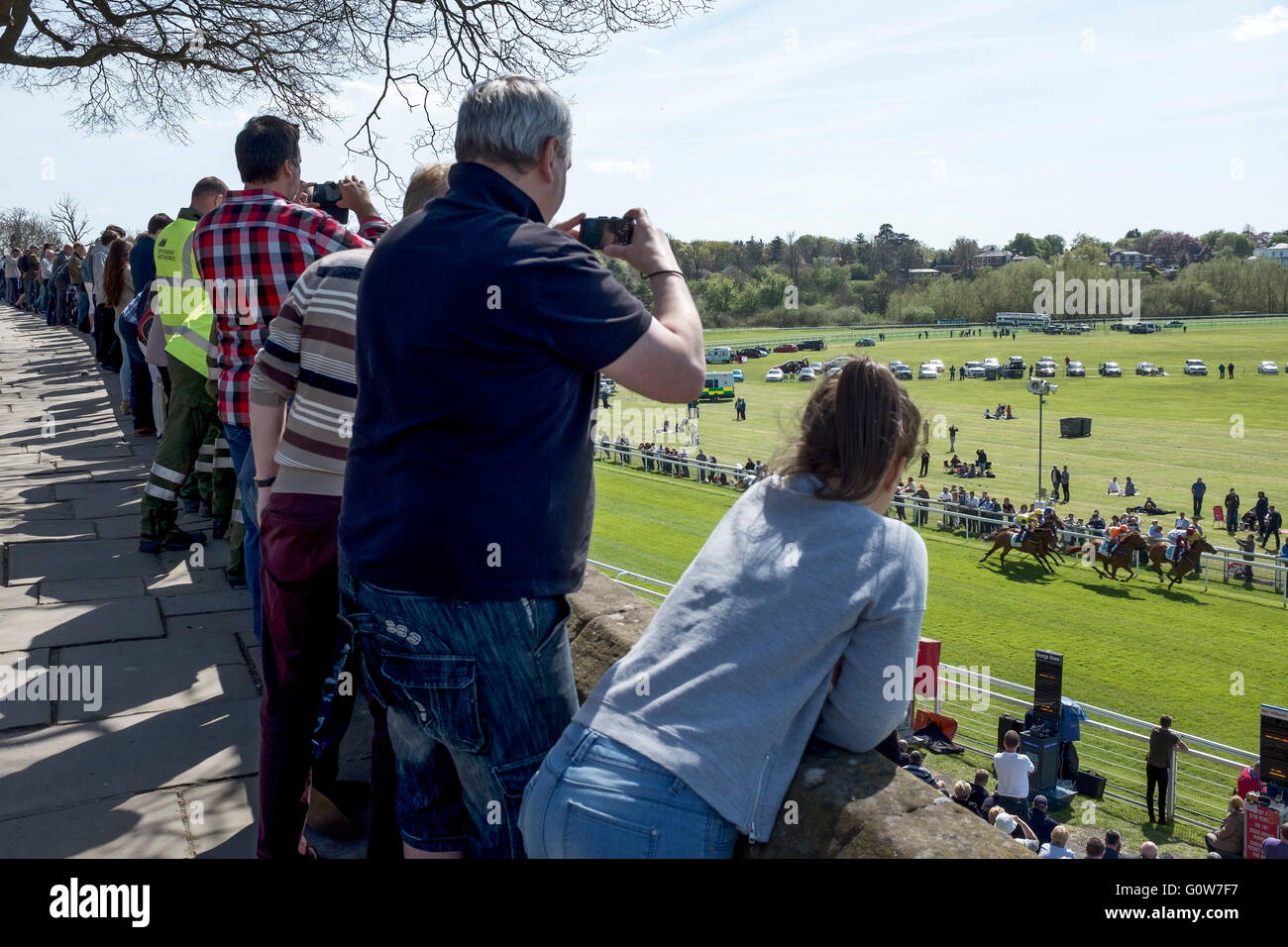Chester, UK. 4th May, 2016. Chester Races. The first race meeting of the 2016 season at Chester Race Course with spectators enjoying the view from the Roman City Walls which run alongside the course and offer a free panoramic view. Credit:  Andrew Paterson/Alamy Live News Stock Photo