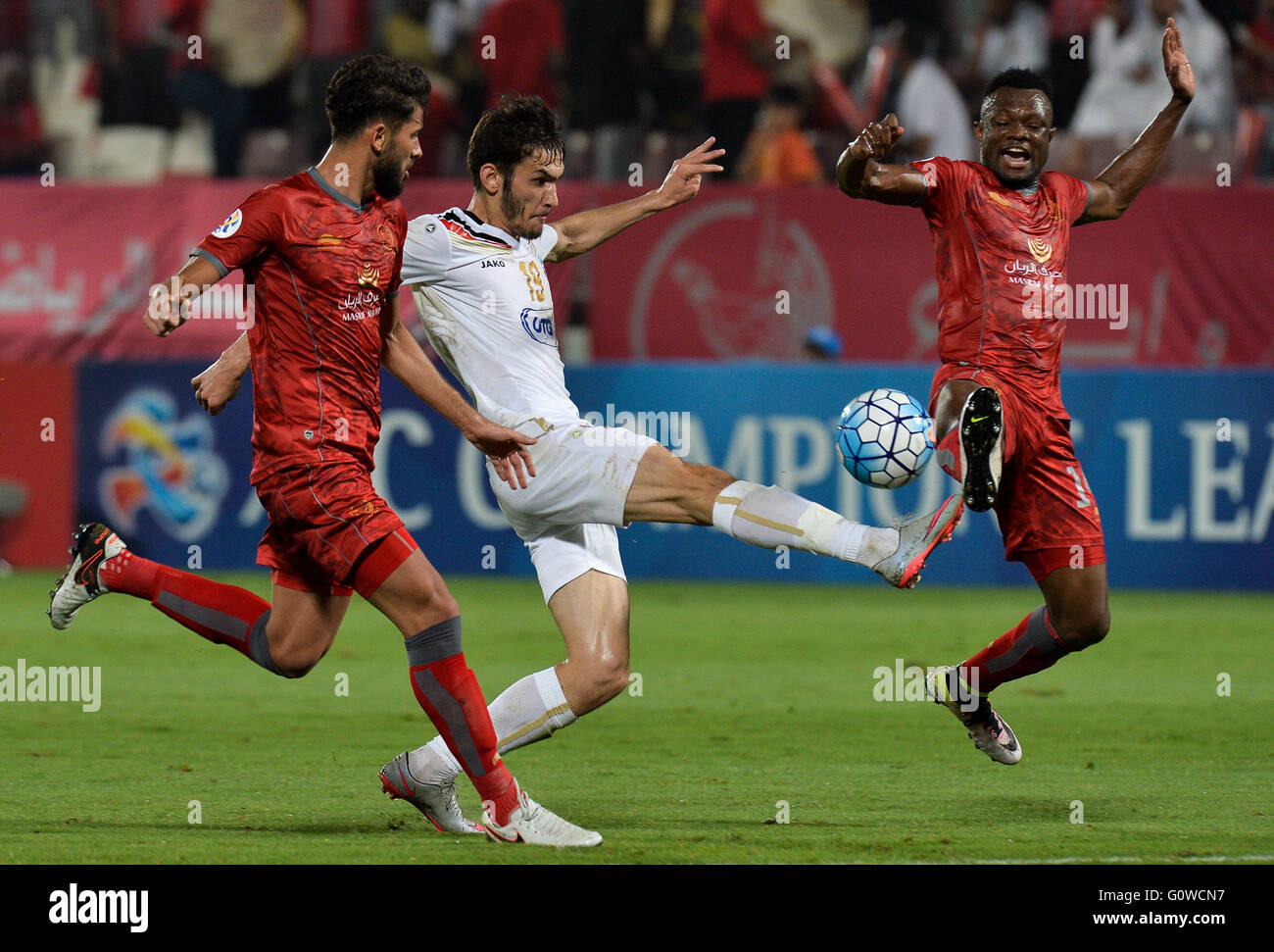 Doha, Qatar. 4th May, 2016. Khaled Radwan (L) and Mohammed Tresor (R) of Qatar's Lekhwiya vies with Urinboev Zabikhillo of Uzbekistan's FC Bunyodkor during the AFC Asian Champions League group B football match at Lekhwiya stadium in Doha, Qatar, May 4, 2016. The match ended 0-0. © Nikku/Xinhua/Alamy Live News Stock Photo