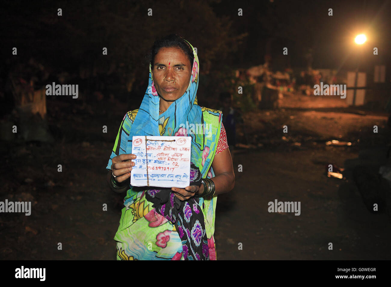 Mumbai, Maharashtra, India. 1st May, 2016. 1 May 2016 - Mumbai - INDIA.Lalita Jadhav Displays the identity plaque given to her at The Temporary Drought Refugee Camp at Barvenagar at Ghatkopar in Mumbai.India's Drought Refugees.Owing to the worst Drought In Maharashtra in decades ; migration to cities has now become a massive phenomena among those affected by the continuing drought. © Subhash Sharma/ZUMA Wire/Alamy Live News Stock Photo