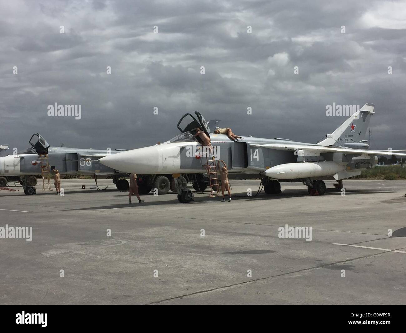 Latakia, Syria. 04th May, 2016. Russian troops prepare a Bomber Sukhoi Su-24 for an operation in Latakia, Syria, 04 May 2016. The Victory Day celebration will be marked the Russian army also abroad in Syria. A few days prior to the World War memorial on May 9 Russian soldiers on the Hamaimim airbase are in rank and file. Photo: Friedemann Kohler/dpa/Alamy Live News Stock Photo