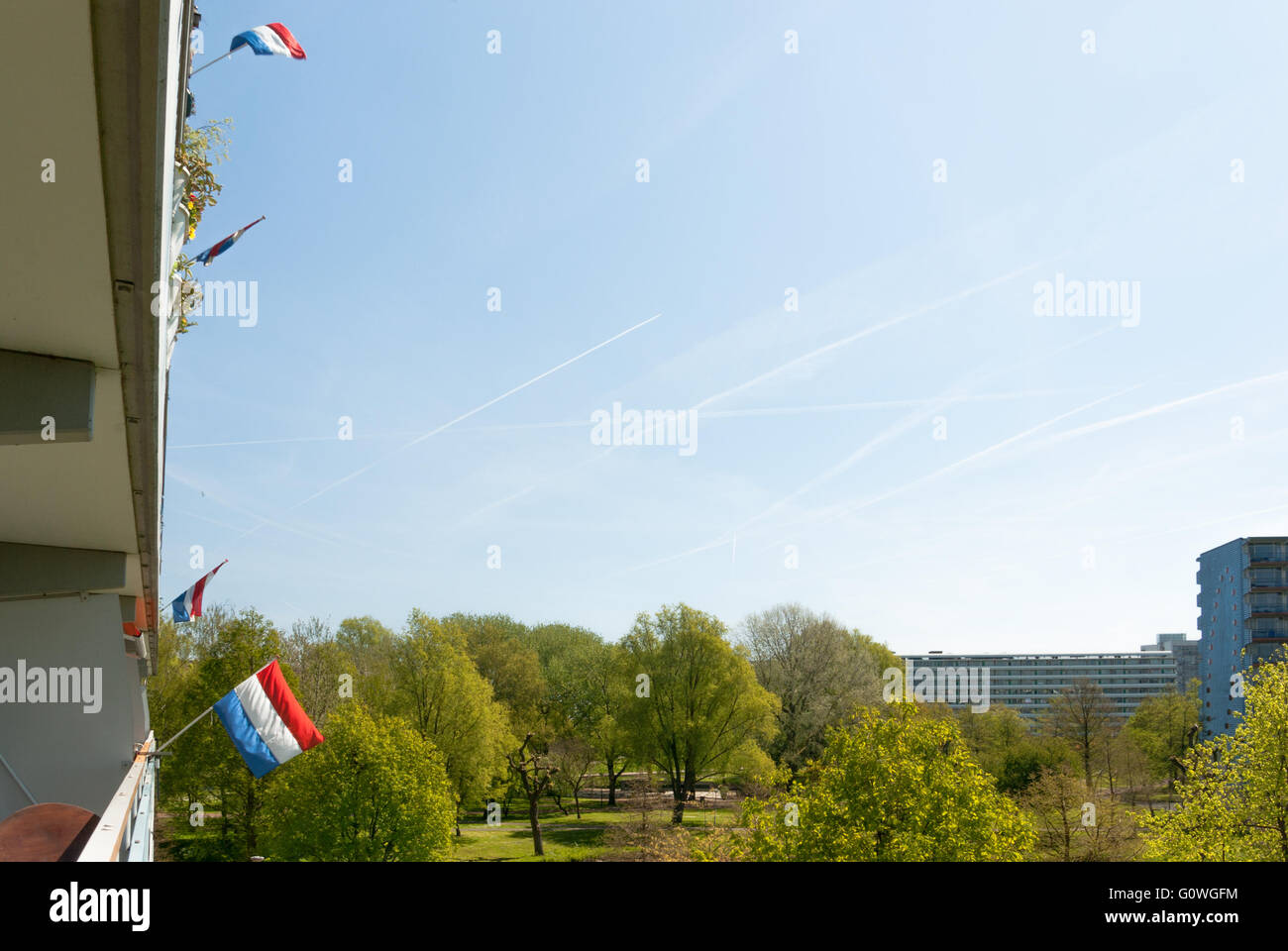 Amsterdam, the Netherlands, 05th May, 2016. On May 5th, Liberation day of the Netherlands, the red-blue-white national flag is seen everywhere. Like here on Gooioord, one of the typical Bijlmer apartment buildings, looking out over the 'Bijlmer monument' area, with the apartment buildings Kikkenstein and Kruitberg in the background, Amsterdam Southeast, the Netherlands. Credit:  Steppeland/Alamy Live News Stock Photo