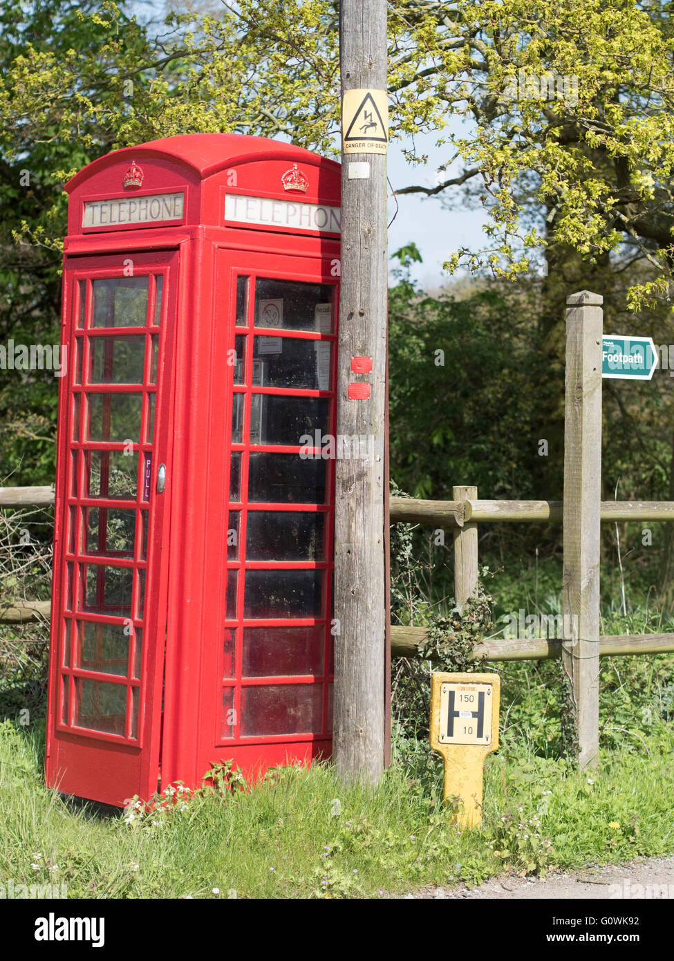 An old-style traditional British red telephone box in a rural setting. Stock Photo