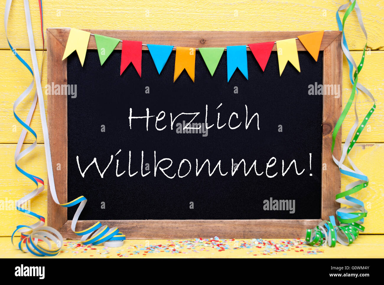 Chalkboard With Party Decoration, Text Herzlich Willkommen Means Welcome Stock Photo