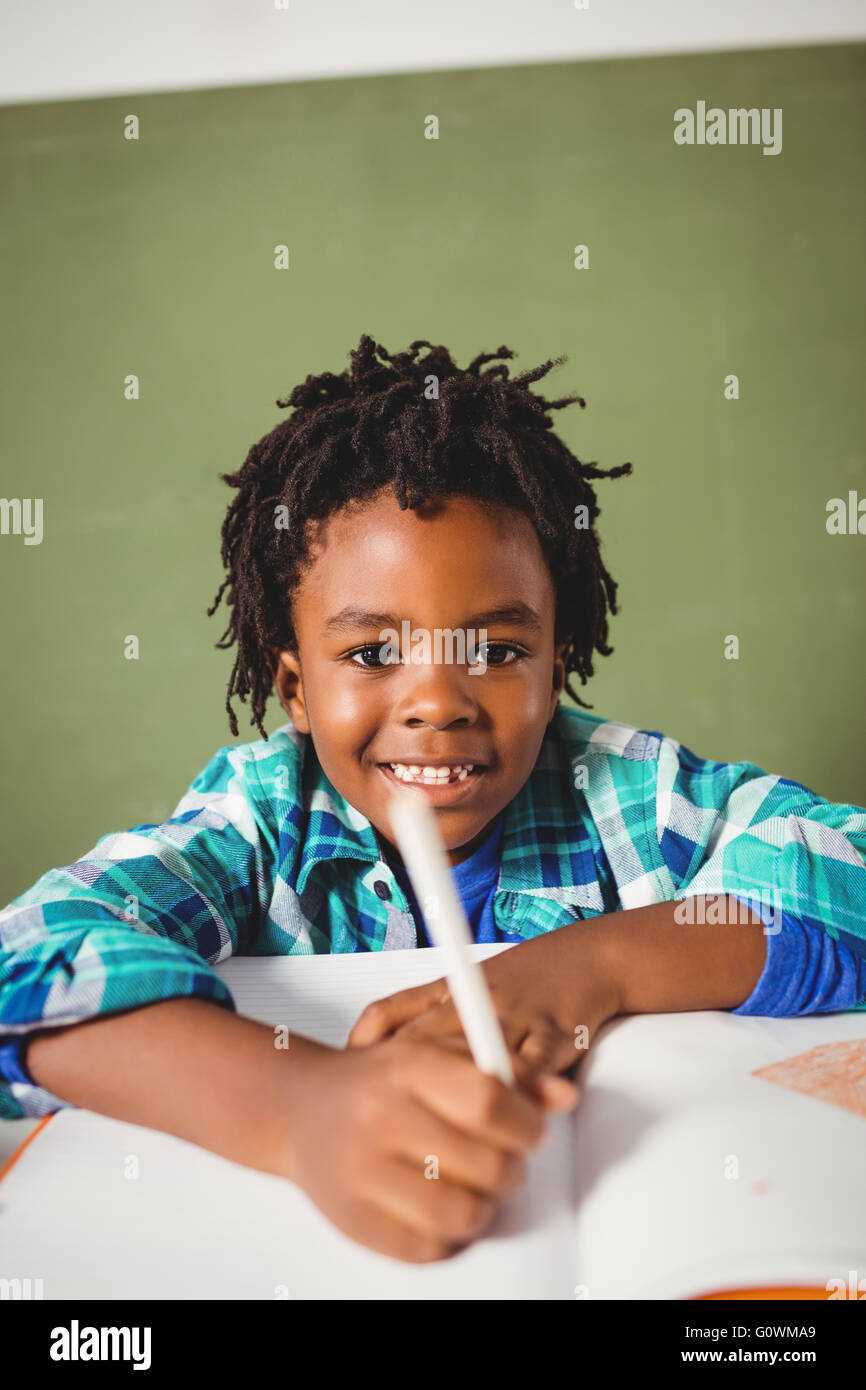 Boy writing in his notebook Stock Photo