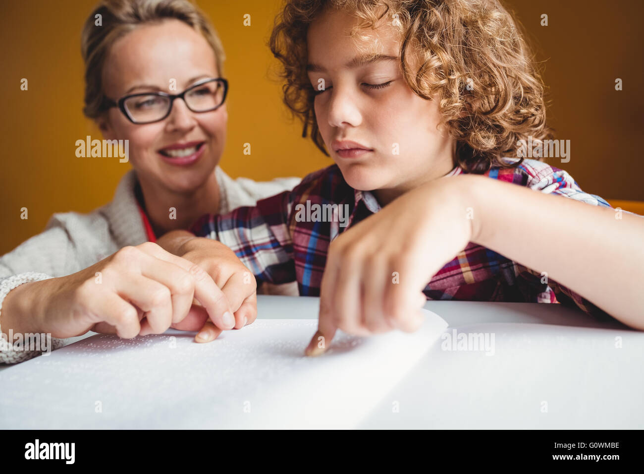 Boy using braille to read Stock Photo - Alamy