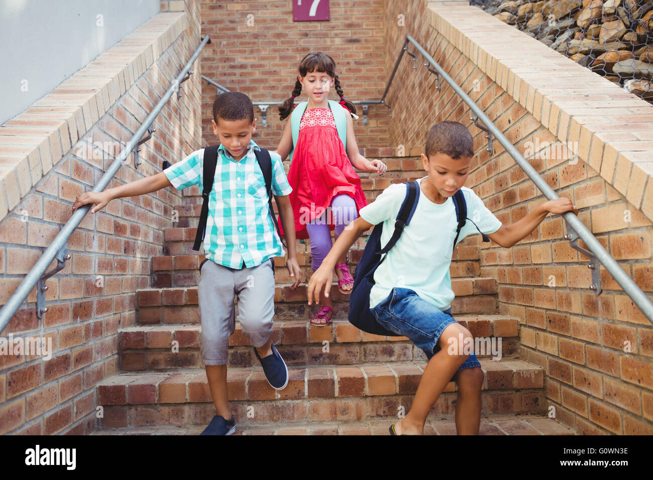 Kids going down the stairs Stock Photo