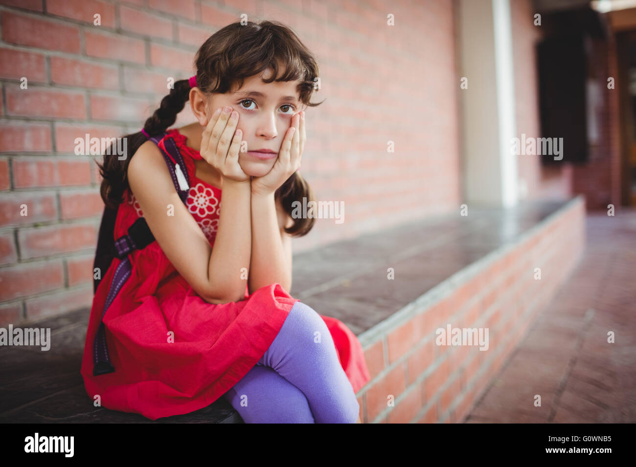 Girl holding her cheek Stock Photo