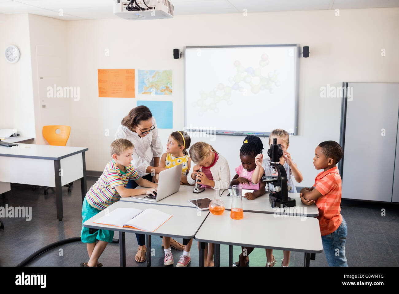 Teacher having science lesson Stock Photo - Alamy