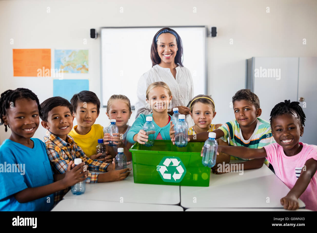 Portrait of pupils and teacher recycling Stock Photo