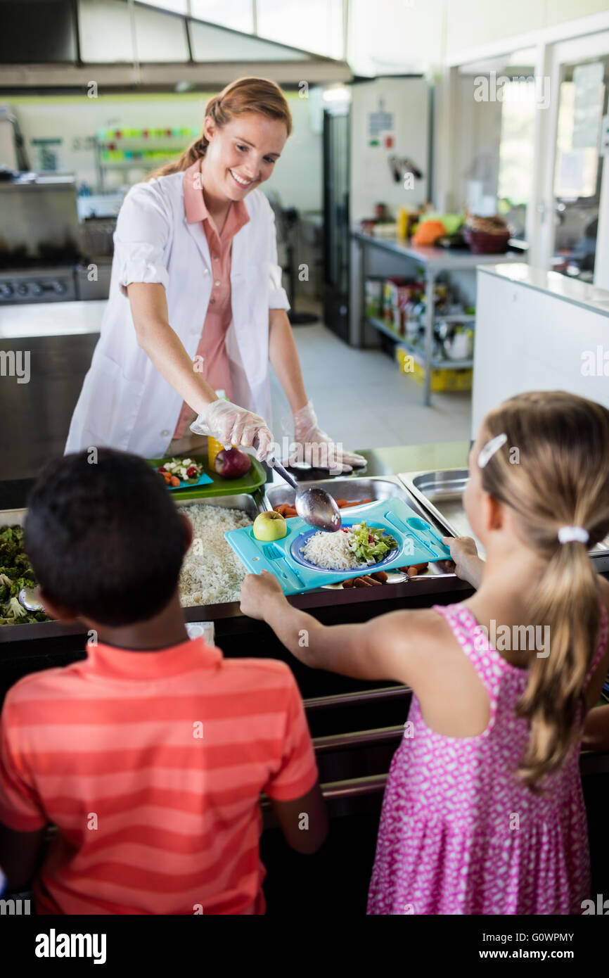 Cooker serving children Stock Photo
