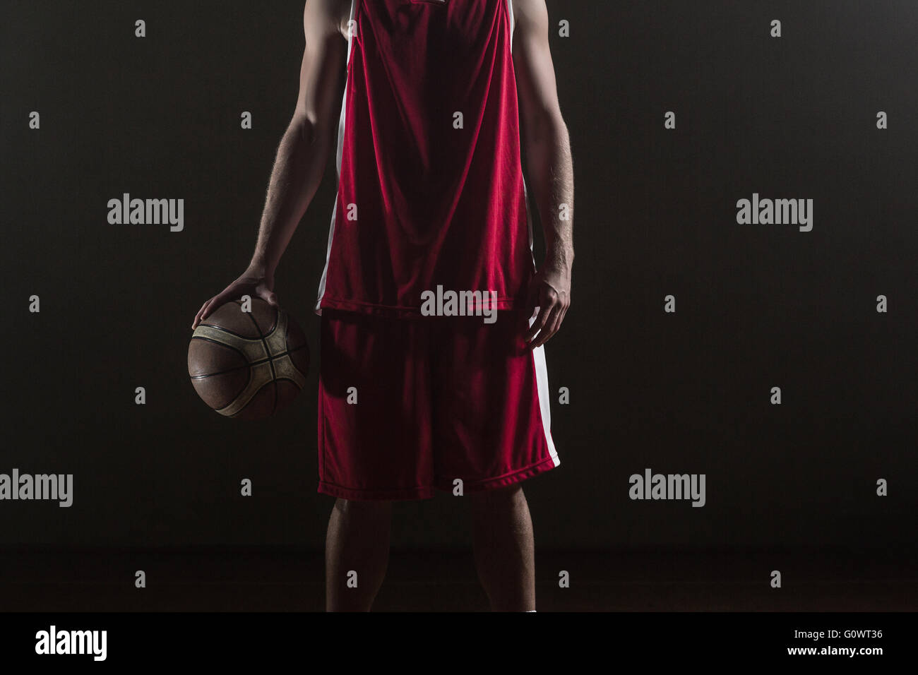 Portrait of basketball player holding a ball Stock Photo