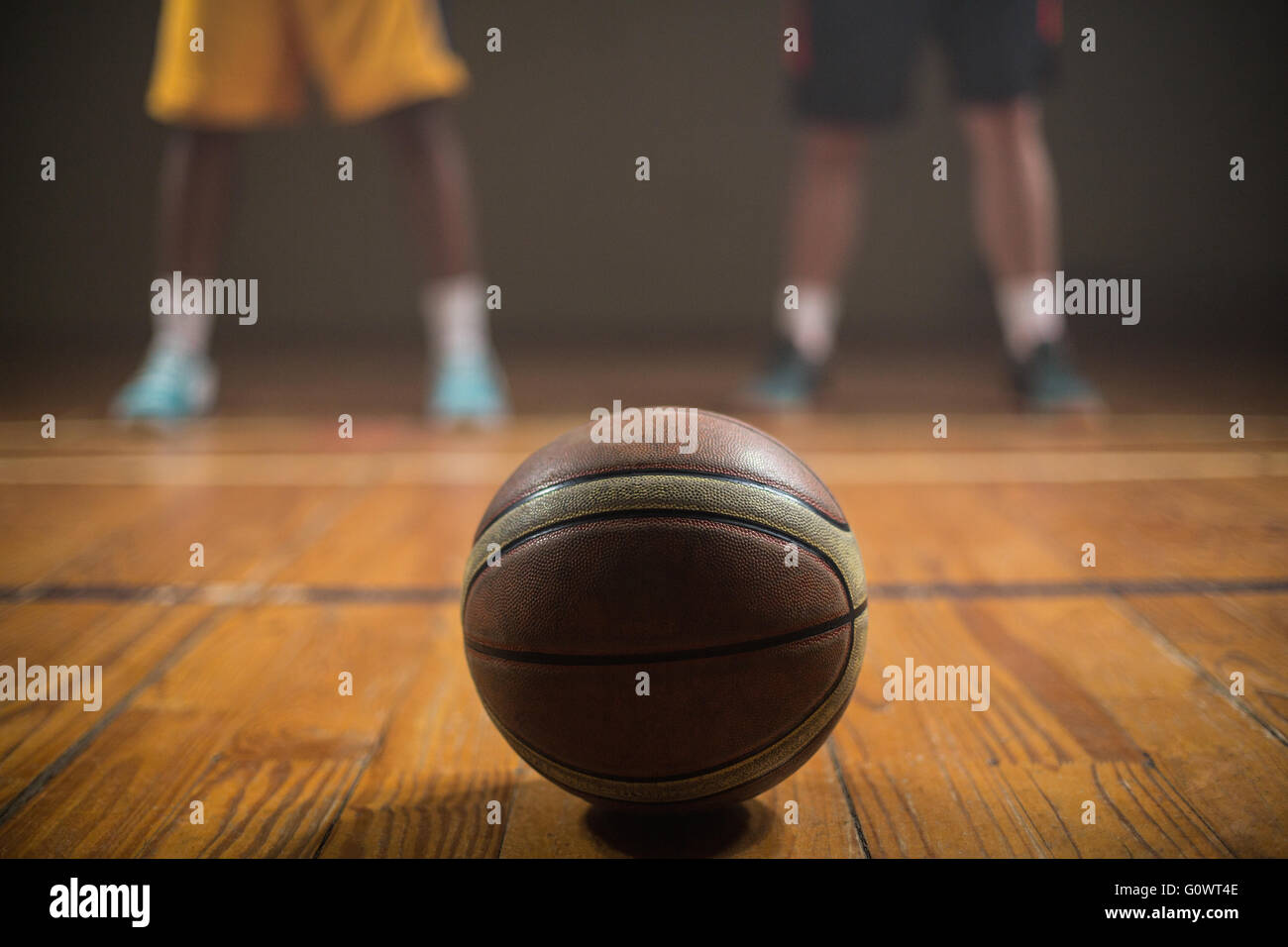 Close up on basketball putting on the floor in front of basketball
