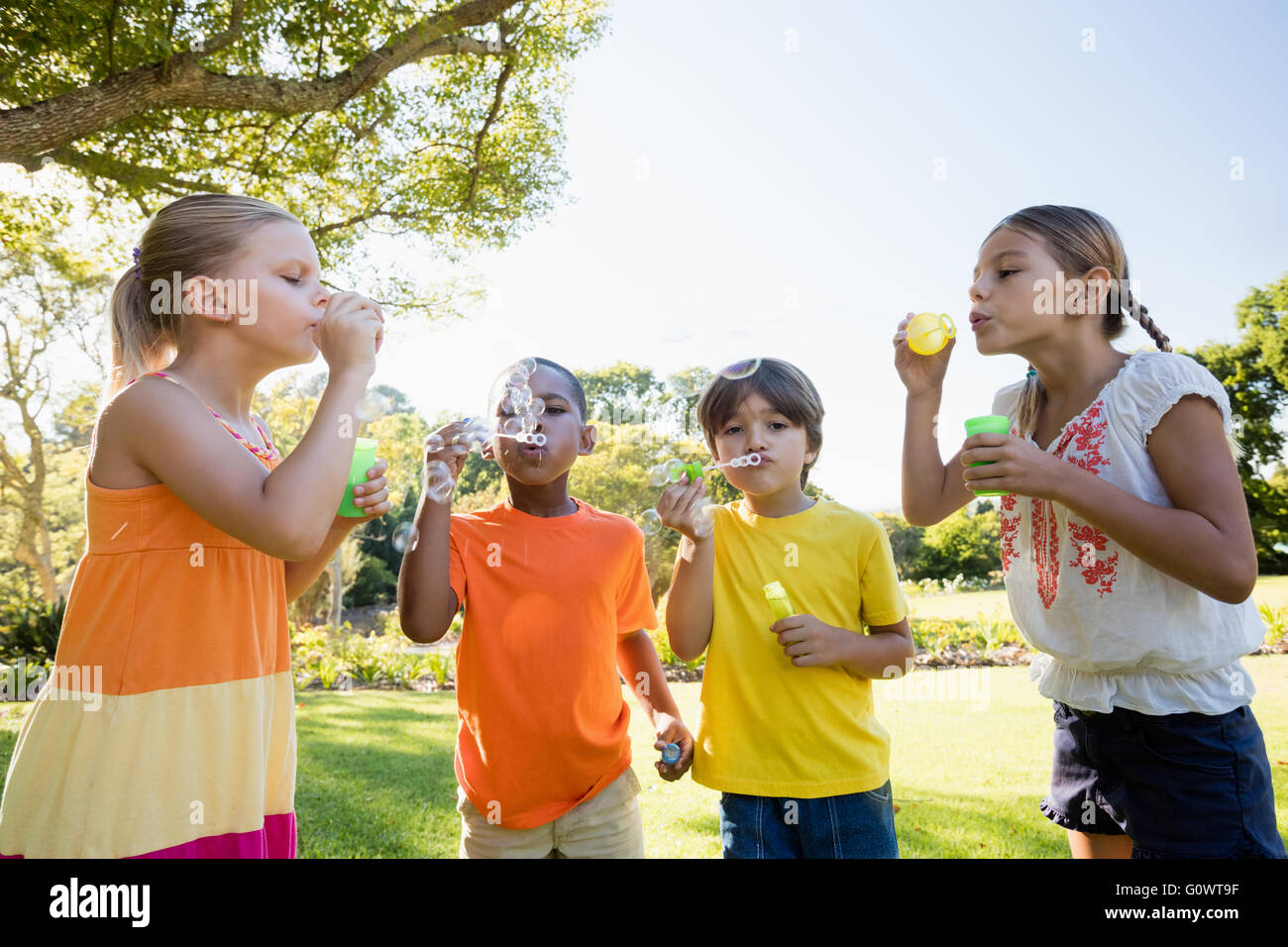 Children playing with bubble wand Stock Photo