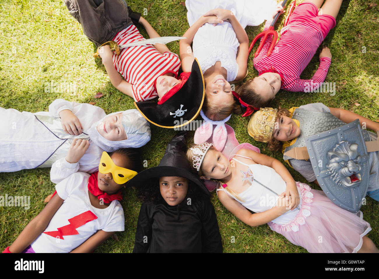 Happy children lying on the grass Stock Photo