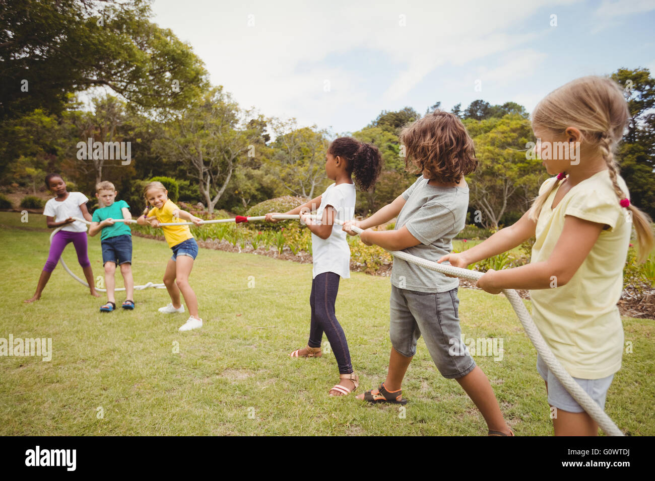 Children pulling a rope in tug of war Stock Photo