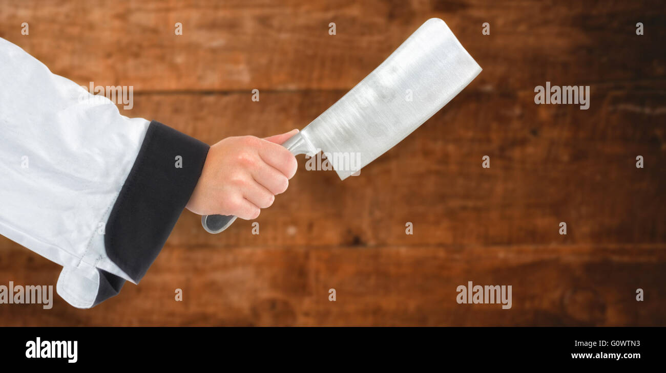 Composite image of chef hand holding a knife Stock Photo