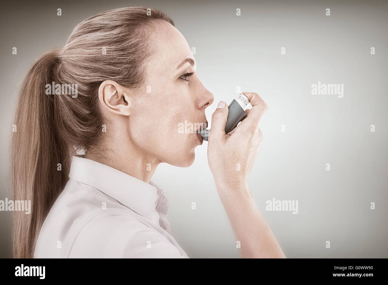 Pretty Inhaler Composite image of pretty blonde using an asthma inhaler Stock Photo ...