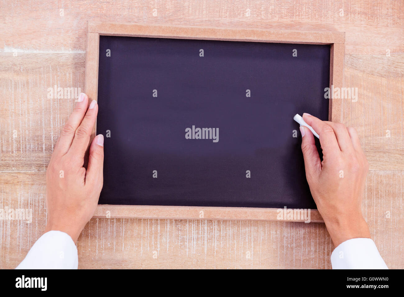 Composite image of chef hand writing on a chalkboard Stock Photo