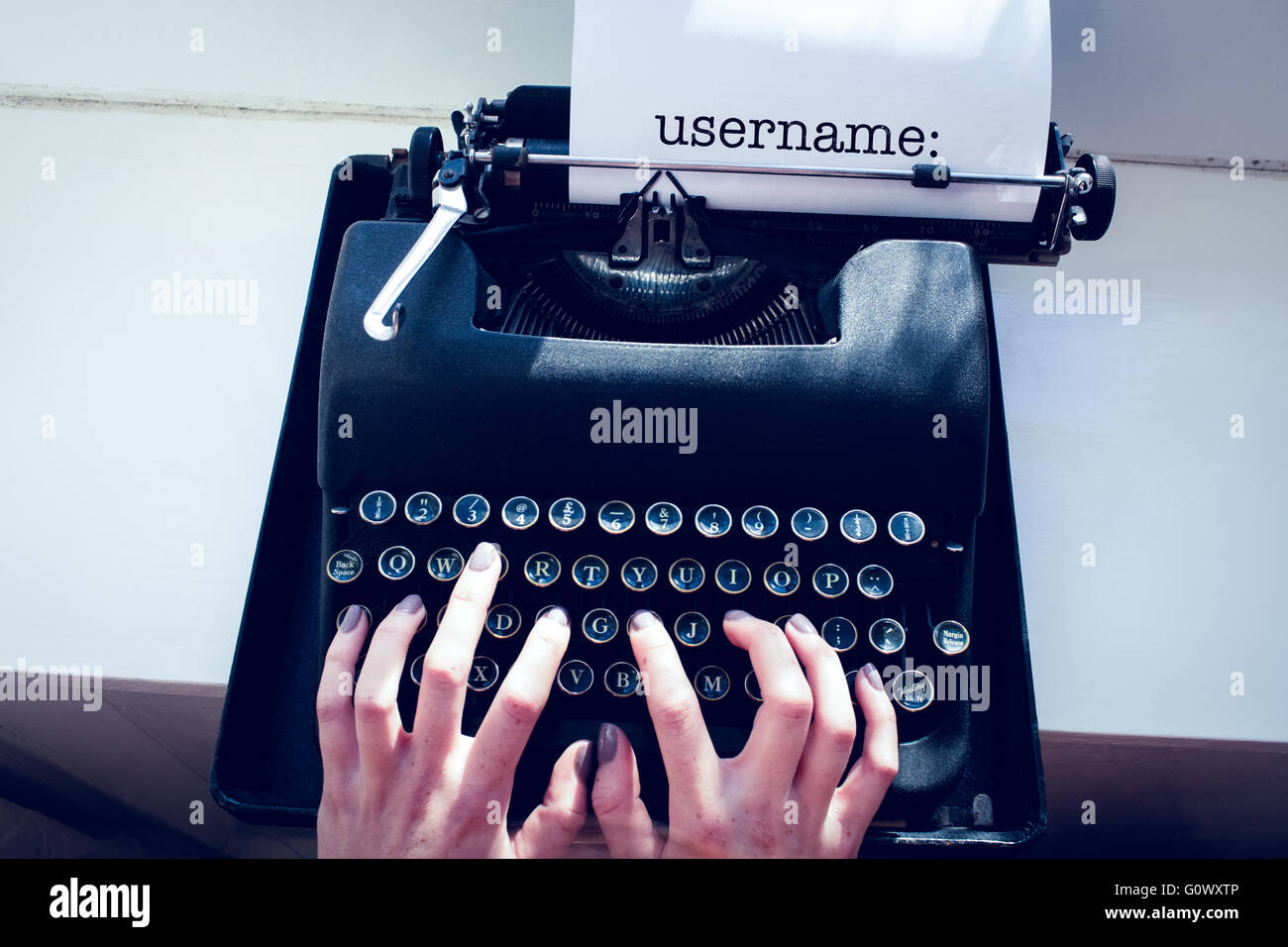 Username: against womans hand typing on typewriter Stock Photo