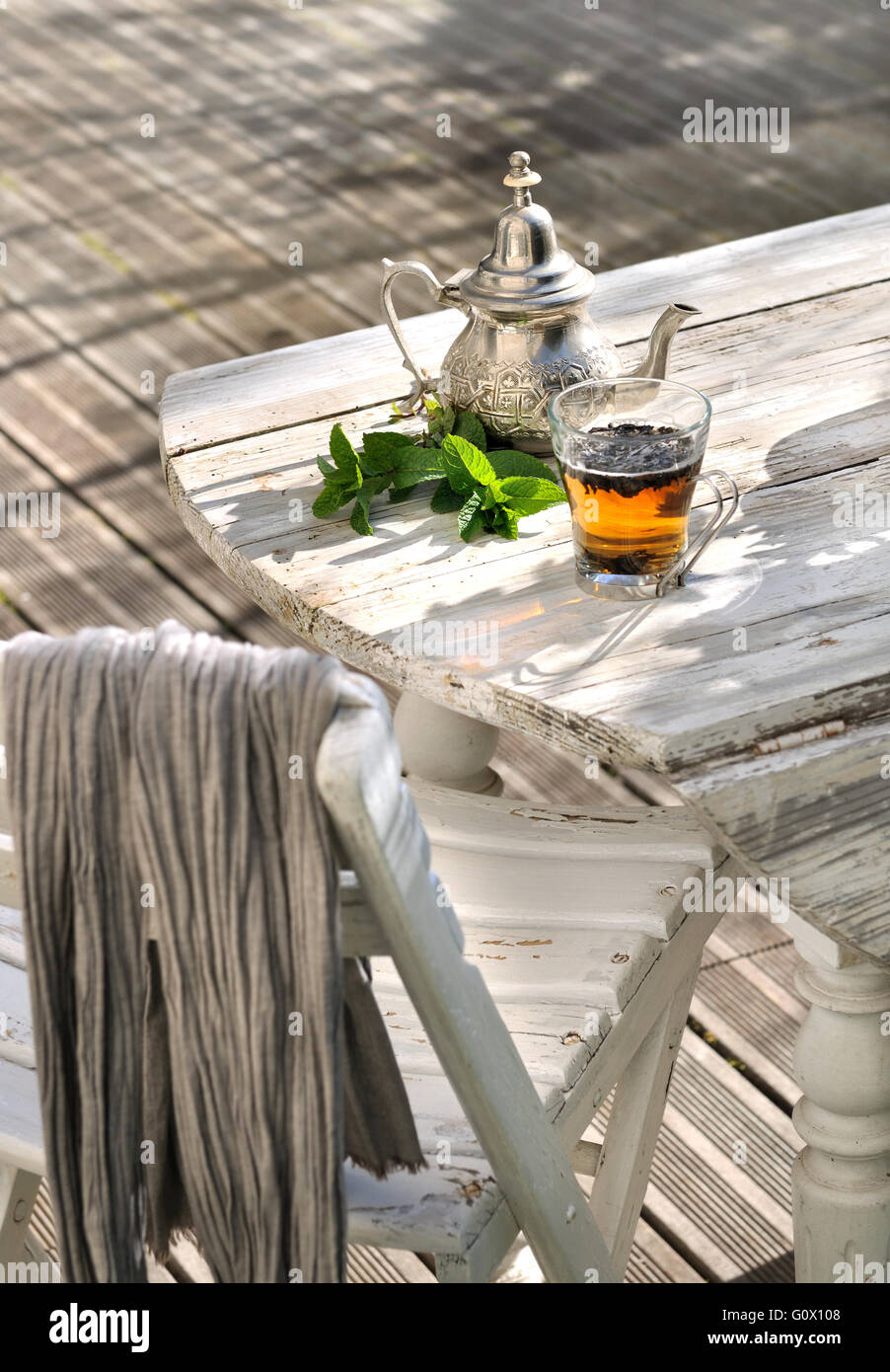 cup of tea with mint leaves on garden table in terrace Stock Photo