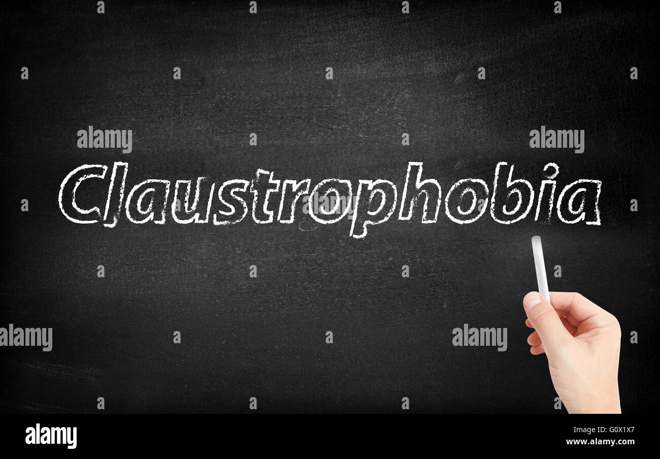 Claustrophobia written on white blackboard Stock Photo