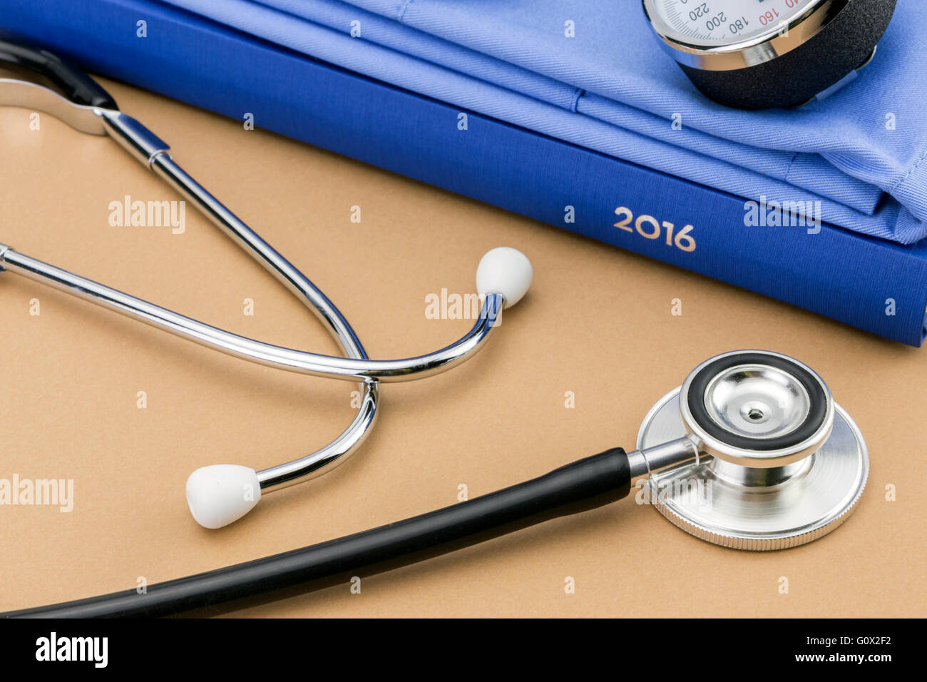 stethoscope and a book on brown background Stock Photo