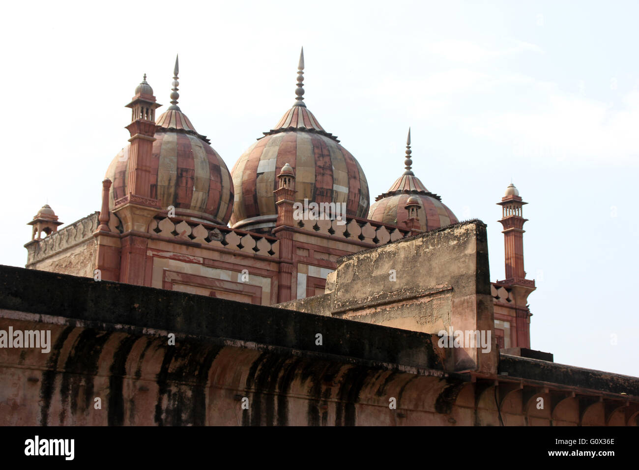 Three domed mosque near gate of Safdarjung Tomb, pleasing structure with small, striped onion domes, slender cuboidal minarets Stock Photo