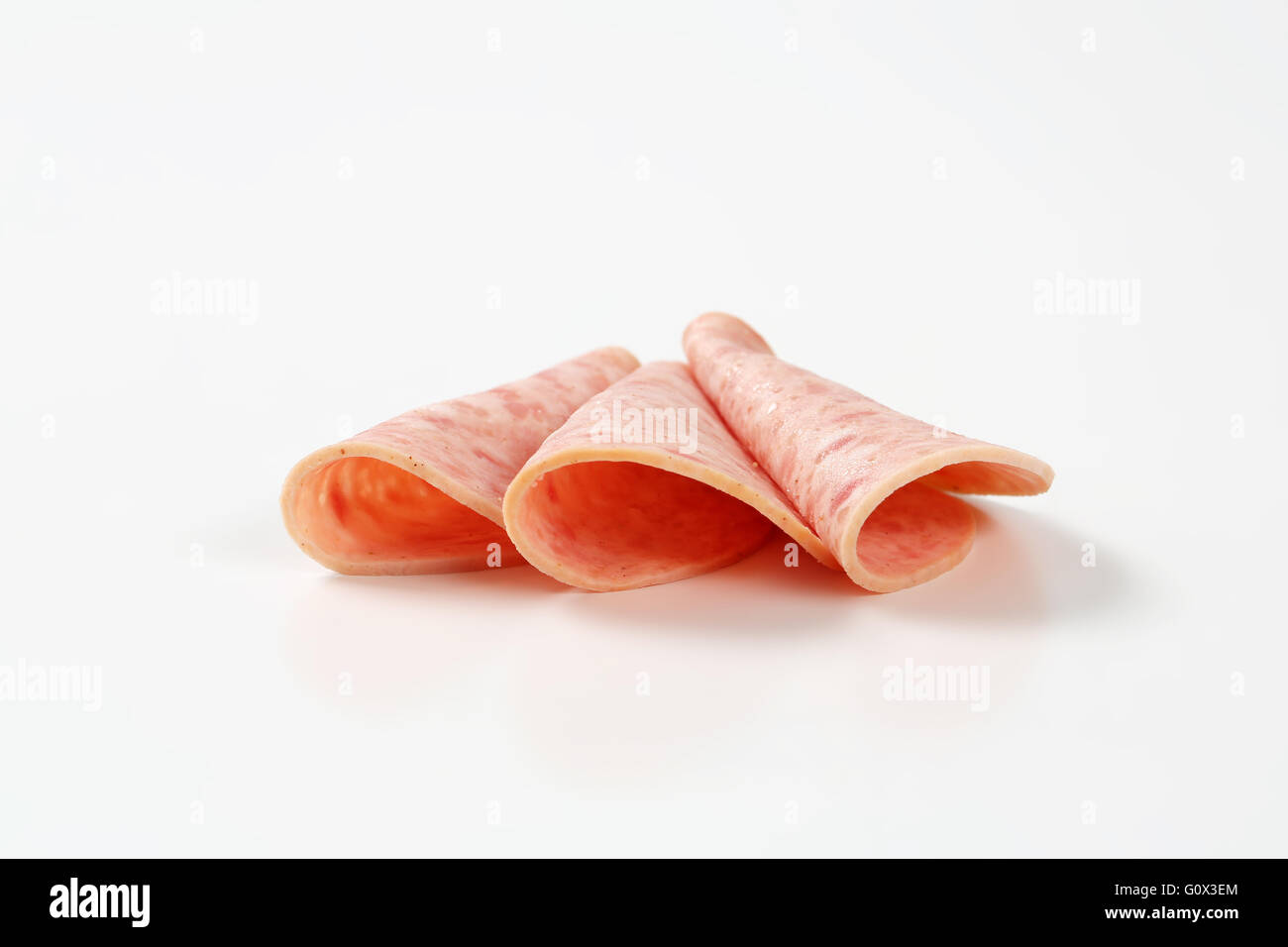 slices of ham salami arranged on white background Stock Photo Alamy