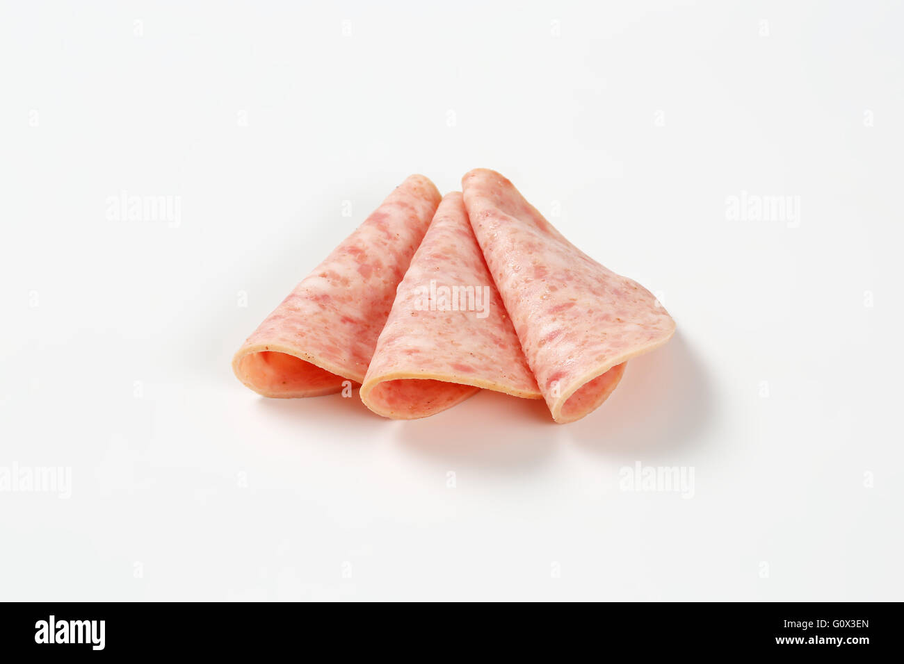 slices of ham salami arranged on white background Stock Photo Alamy