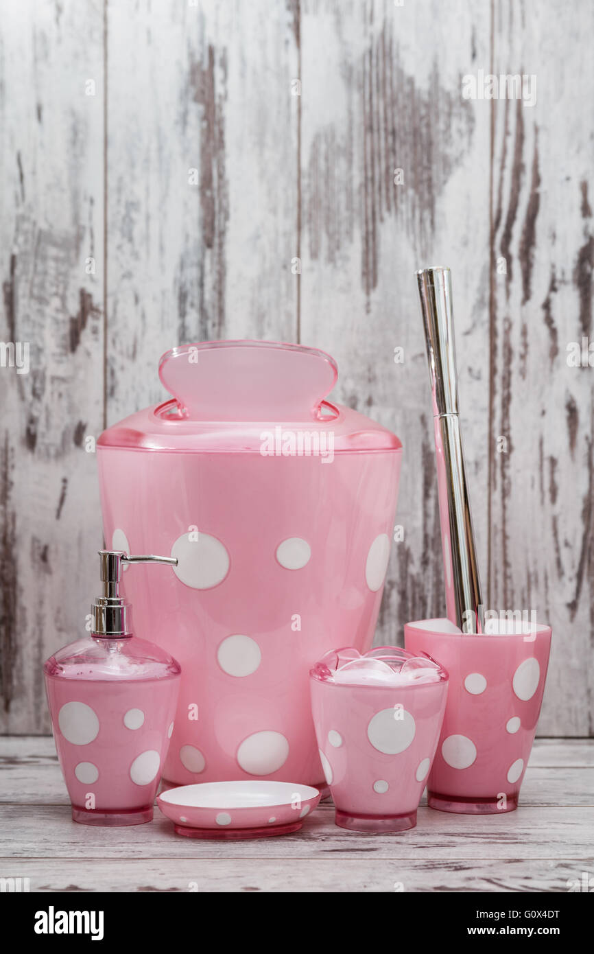 Set of cute pink toilet brush and accessories for bathroom on white