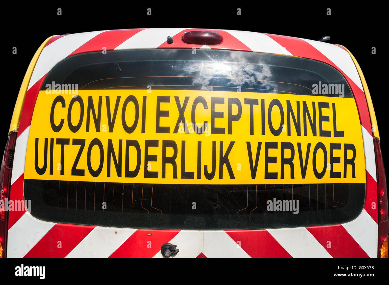 Escort car with the inscription Convoi Exceptionnel for escorting trucks with oversize cargo. Stock Photo