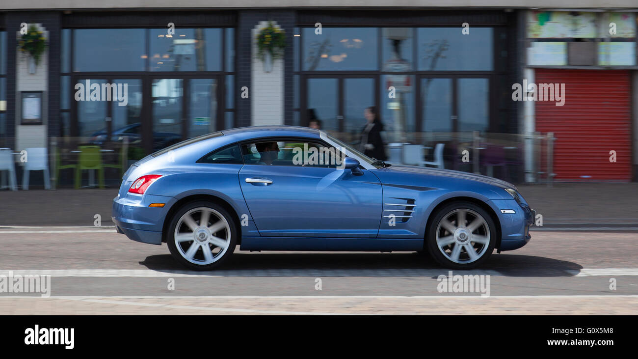 2006 Aero Blue Chrysler Crossfire coupe being driven on Bank Hey Street, Blackpool, Lancashire, UK Stock Photo