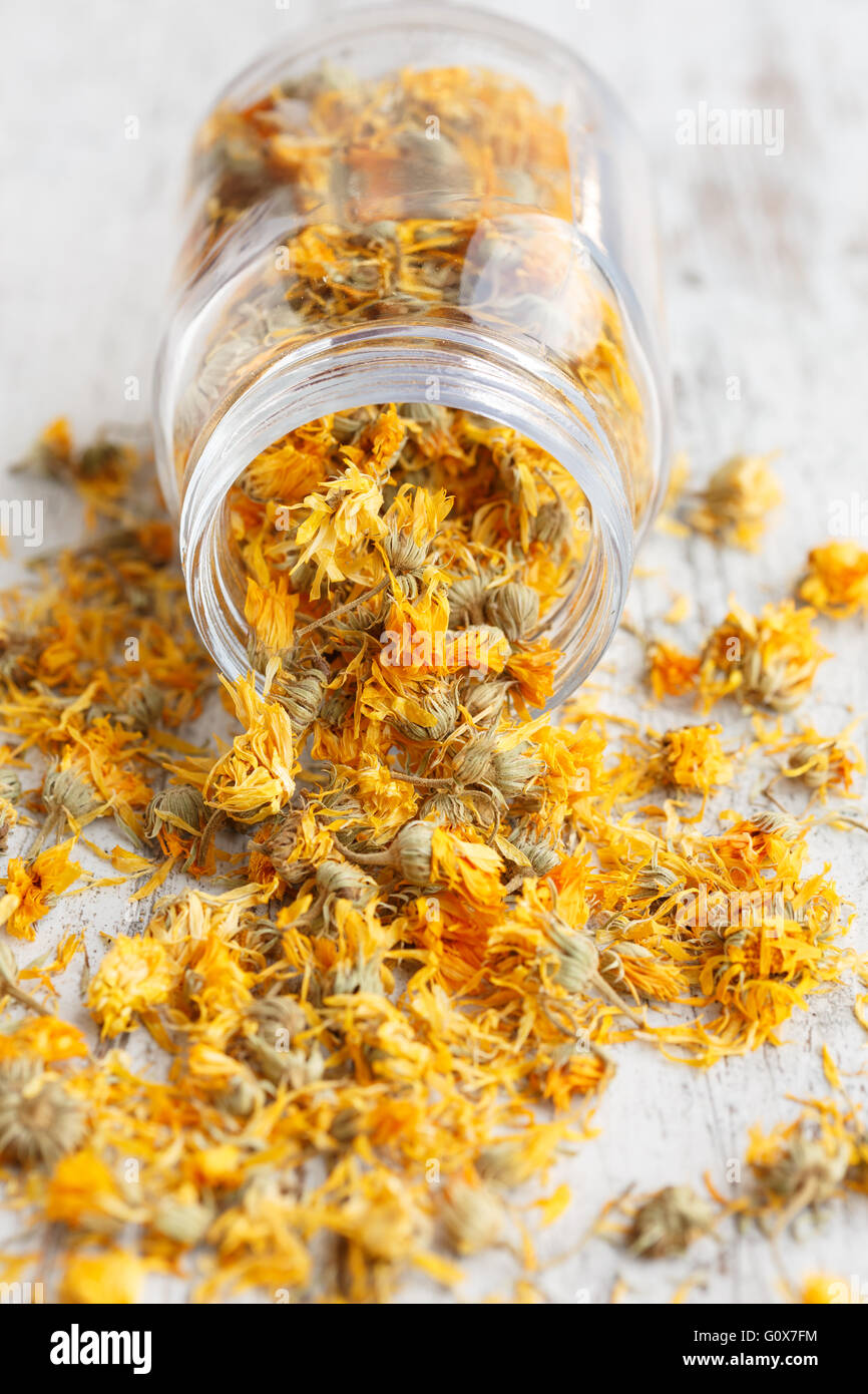 Dried marigold flowers spilling from a glass jar Stock Photo Alamy