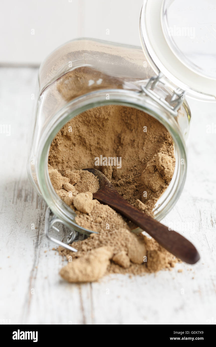 Whole brown sugar cane spilling from a glass jar Stock Photo