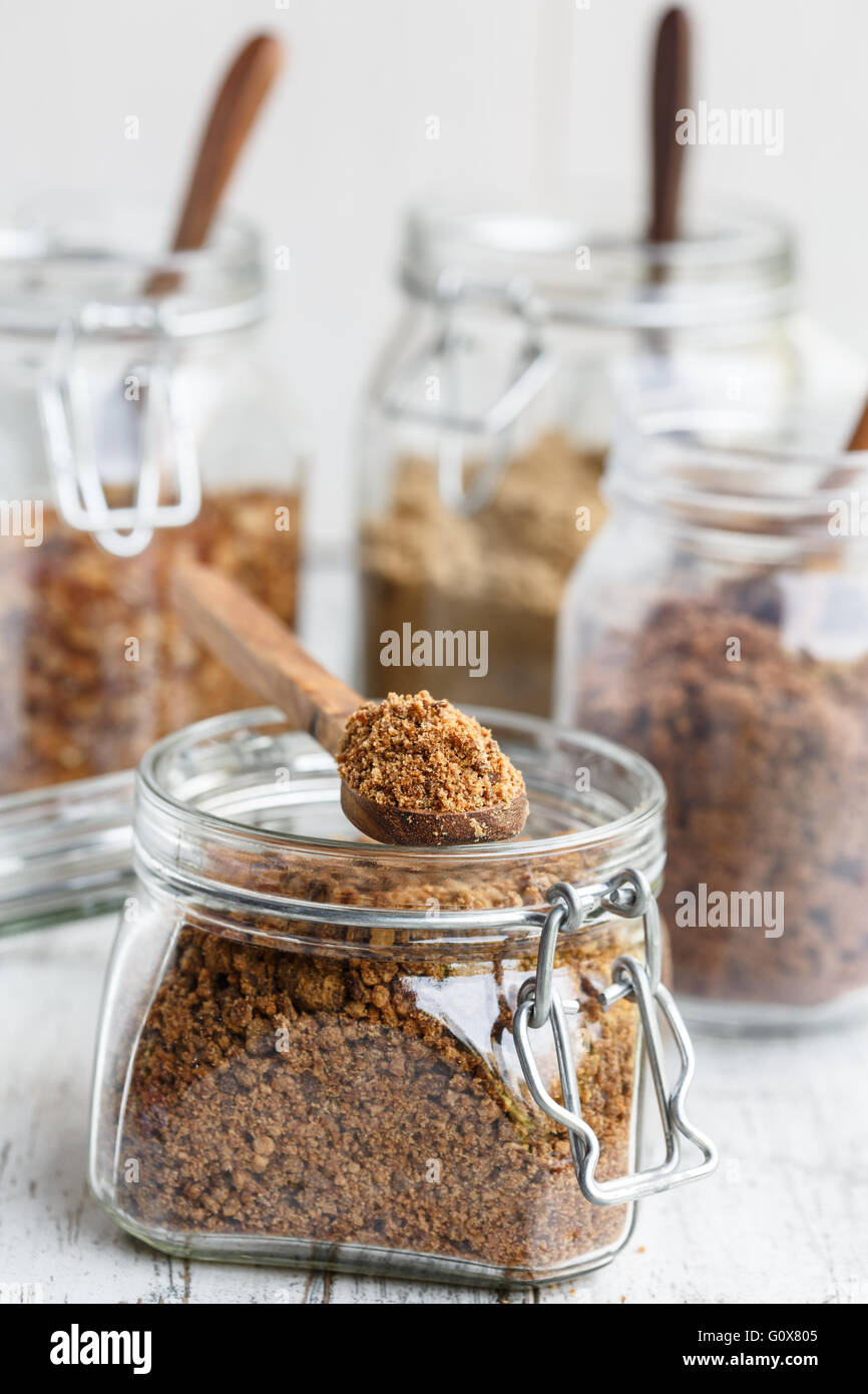 Various types of brown sugar in glass jars Stock Photo