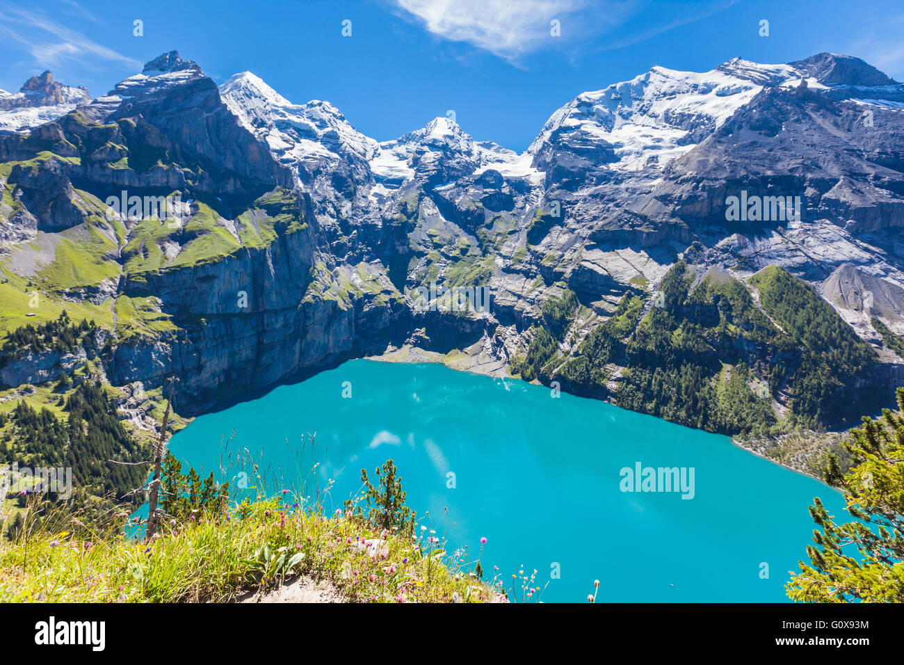 The panorama in summer view over the Oeschinensee (Oeschinen lake) and the alps on the other side near Kandersteg on bernese obe Stock Photo