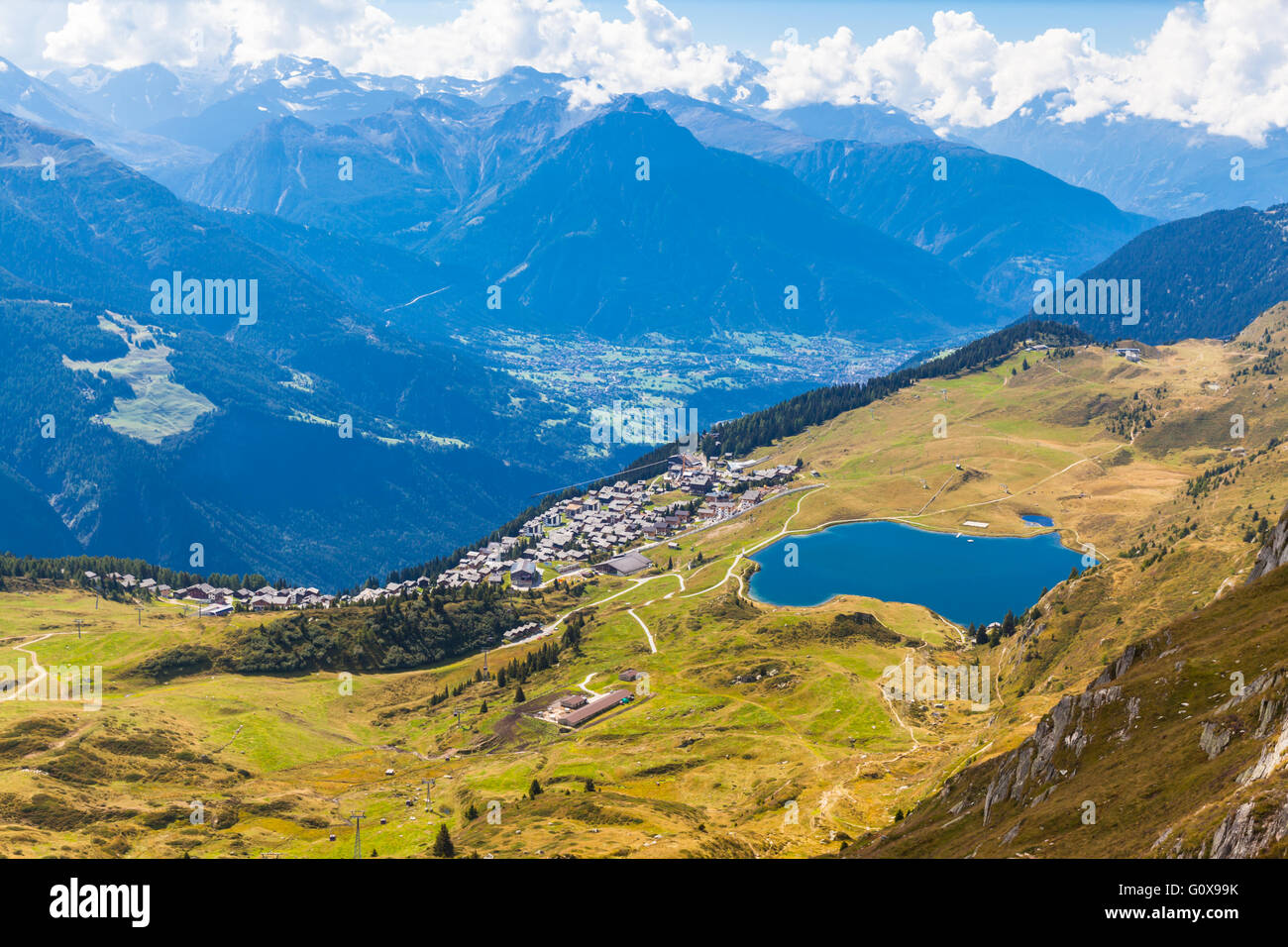 Aerial view of the Bettmersee (Lake) and the Bettmer town, with the numerous peaks of alps as background, in Valais, Switzerland Stock Photo