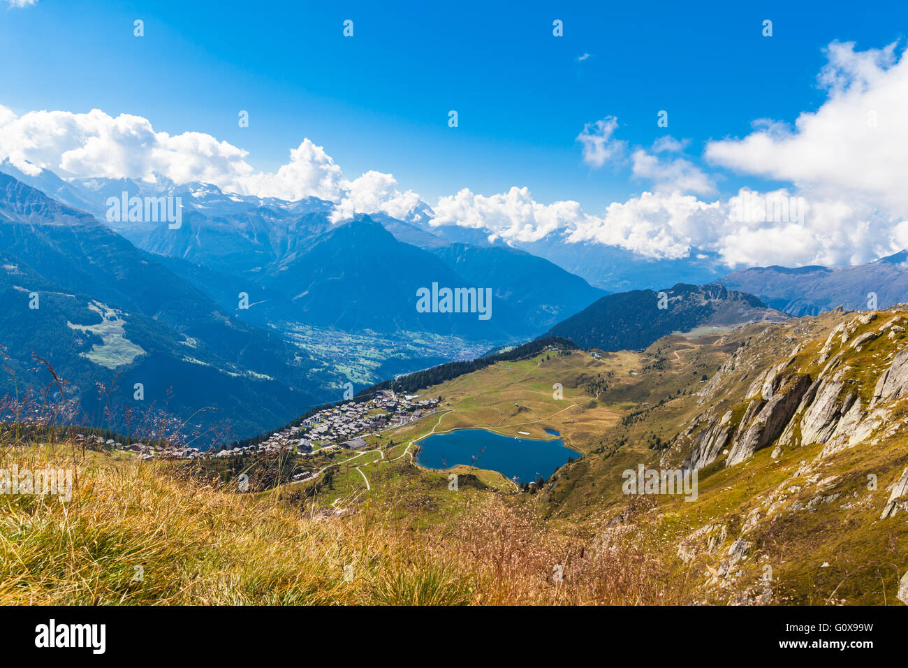 Aerial view of the Bettmersee (Lake) and the Bettmer town, with the numerous peaks of alps as background, in Valais, Switzerland Stock Photo
