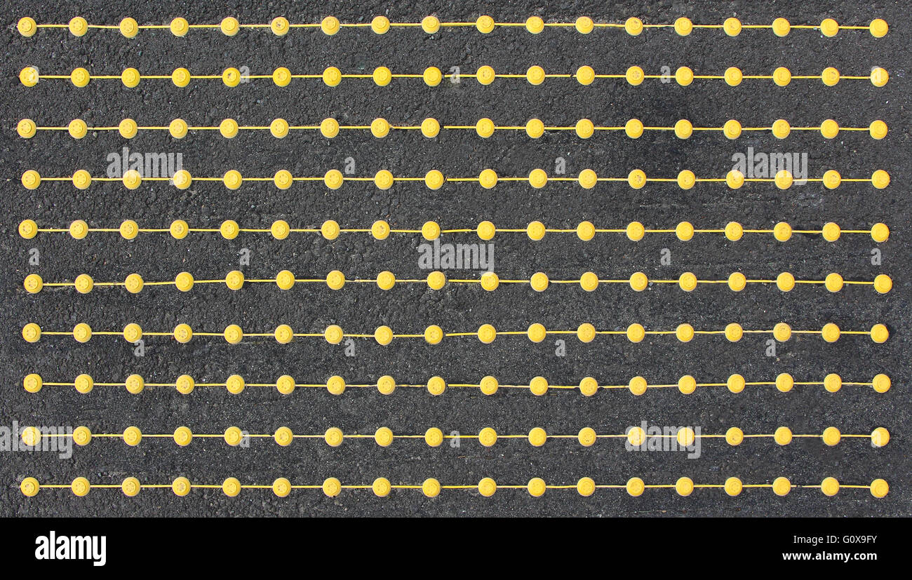 Dotted yellow lines pattern on a rough surface Stock Photo Alamy