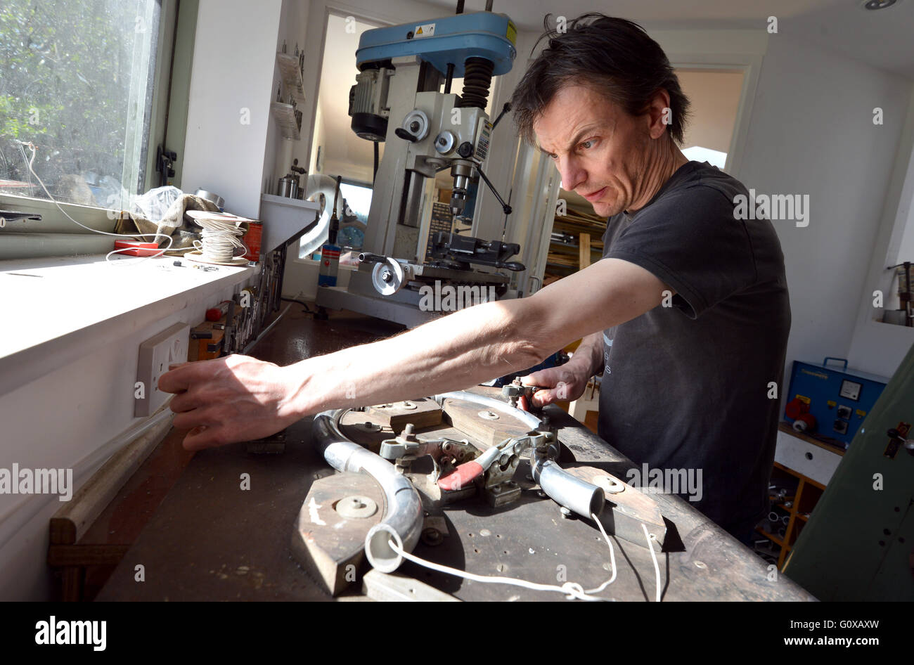 Simon Farmer, founder of Gus Custom Guitars with a guitar designed for Prince, in his East Sussex workshop Stock Photo